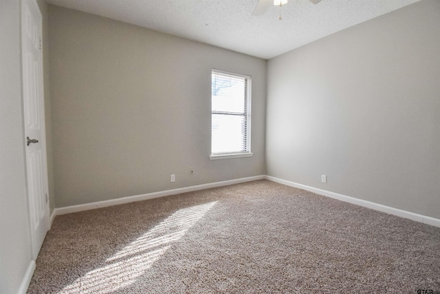 unfurnished room featuring ceiling fan, carpet, and a textured ceiling