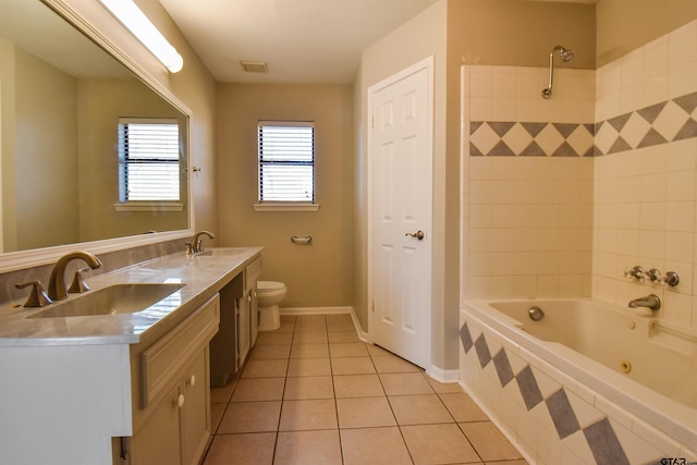 bathroom featuring tile patterned flooring, vanity, toilet, and tiled tub