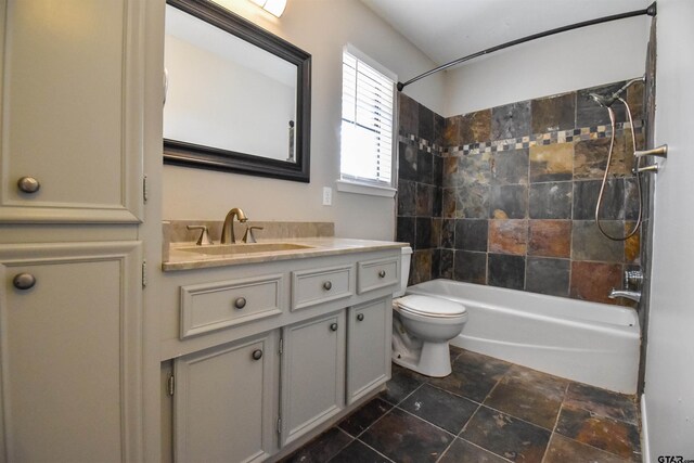 full bathroom featuring vanity, toilet, and tiled shower / bath