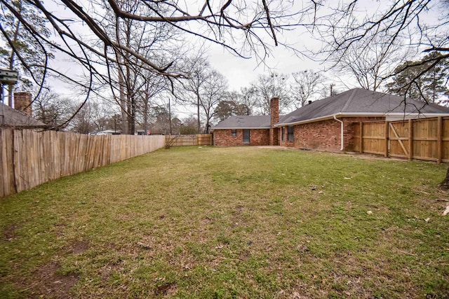 view of yard with a fenced backyard