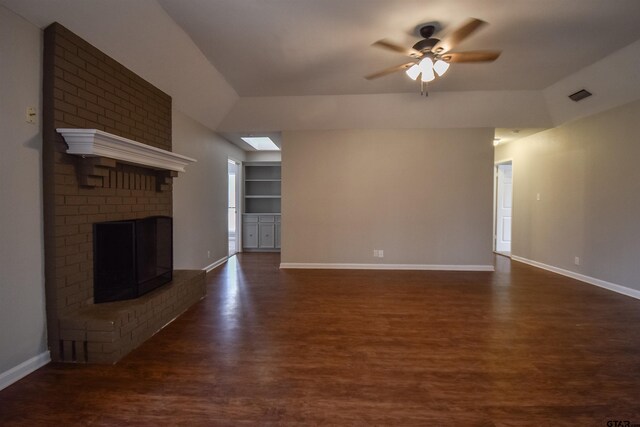 unfurnished dining area featuring a raised ceiling, an inviting chandelier, dark wood-type flooring, and sink