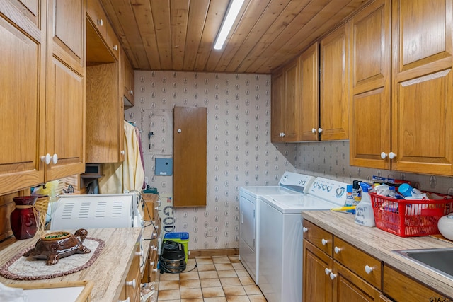 washroom featuring sink, wood ceiling, cabinets, light tile patterned floors, and independent washer and dryer