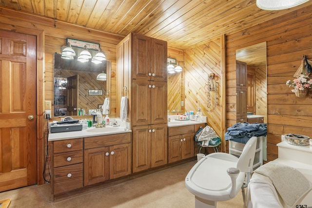 bathroom featuring vanity, wooden ceiling, and wooden walls