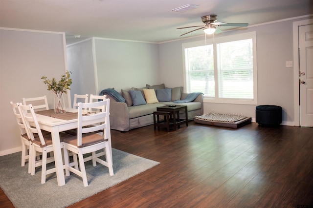 dining area with ornamental molding, ceiling fan, and dark hardwood / wood-style floors