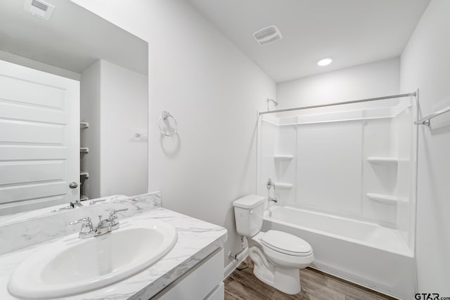 full bathroom featuring wood-type flooring, vanity, toilet, and shower / bath combination