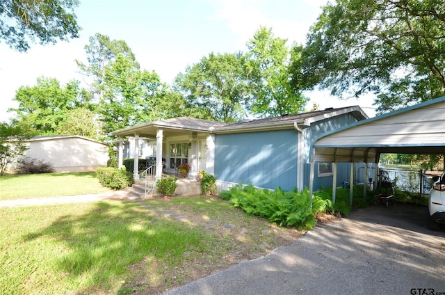 116 Piney Pt, Murchison, TX 75778 - view of front of home with a front lawn, a porch, and a carport