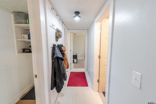 hall with baseboards and light wood-type flooring