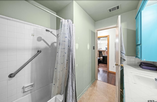 bathroom featuring vanity and shower / bathtub combination with curtain