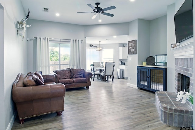 1112 E Park Dr, Lindale, TX 75771 - living room featuring a fireplace, wood finished floors, a ceiling fan, baseboards, and recessed lighting