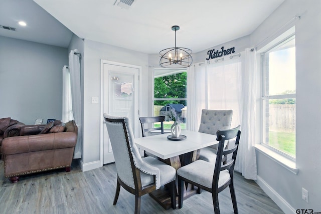 1112 E Park Dr, Lindale, TX 75771 - dining area with baseboards, healthy amount of natural light, a chandelier, and light wood-style flooring