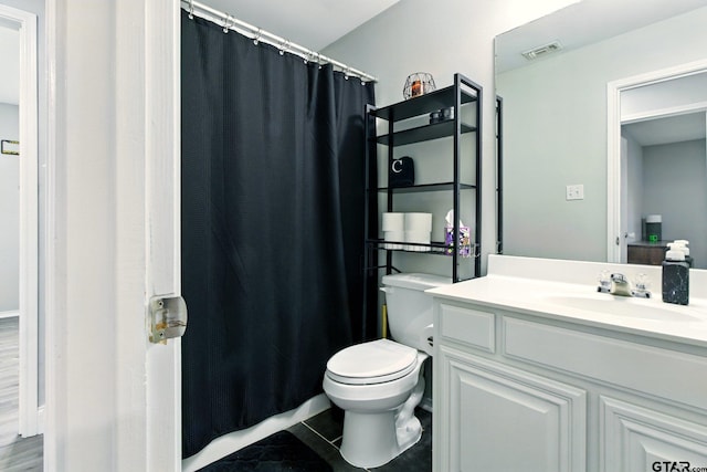 1112 E Park Dr, Lindale, TX 75771 - bathroom with vanity, toilet, curtained shower, and tile patterned floors