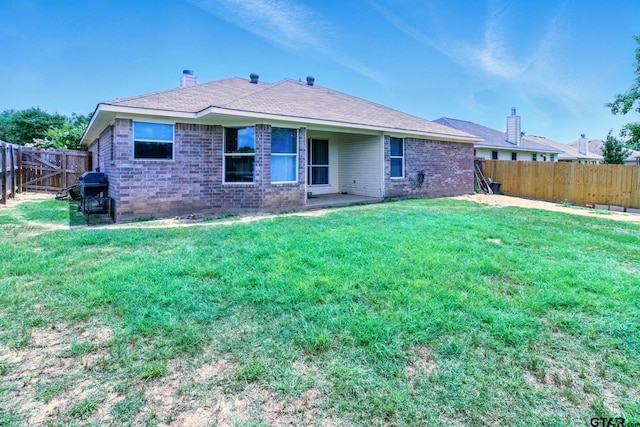 1112 E Park Dr, Lindale, TX 75771 - back of property featuring brick siding and a chimney
