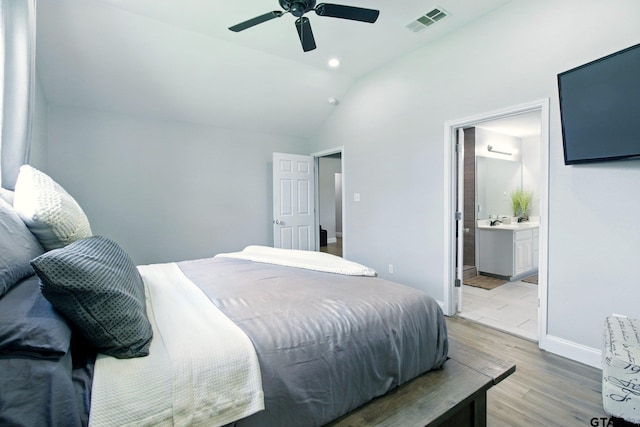 1112 E Park Dr, Lindale, TX 75771 - bedroom featuring light wood-style floors, lofted ceiling, ensuite bath, baseboards, and ceiling fan