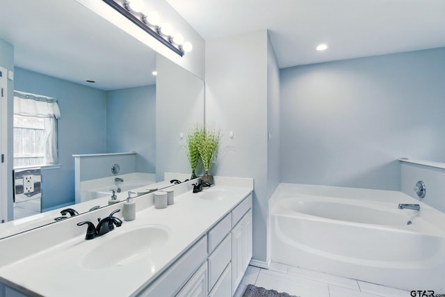1112 E Park Dr, Lindale, TX 75771 - bathroom with a garden tub, double vanity, tile patterned floors, and recessed lighting