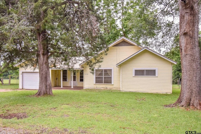 view of front of home with a porch, a garage, and a front lawn