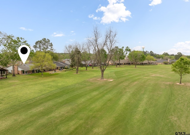 surrounding community with a lawn and view of golf course