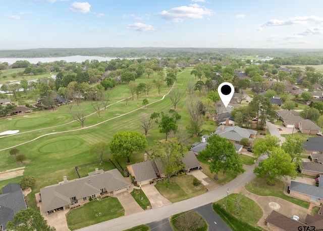 birds eye view of property featuring view of golf course, a residential view, and a water view