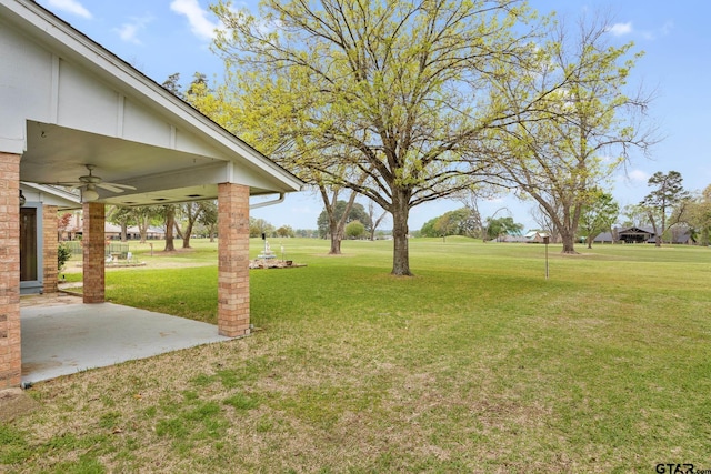 view of yard with a patio and a ceiling fan