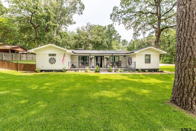 back of house featuring a porch and a yard