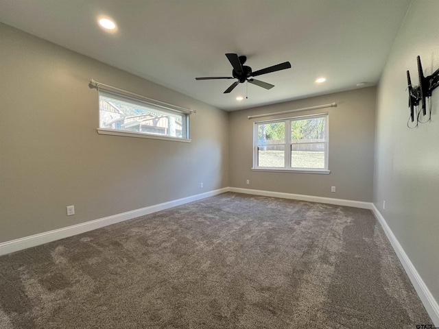 carpeted empty room with a healthy amount of sunlight and ceiling fan