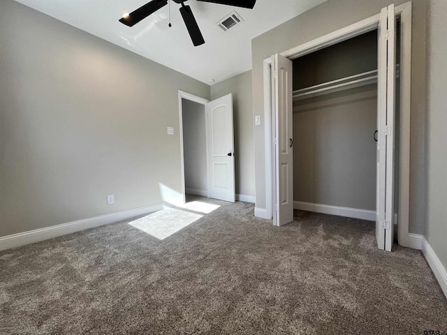 unfurnished bedroom with a closet, ceiling fan, and dark carpet