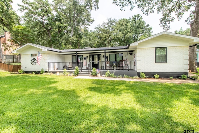 ranch-style house with covered porch and a front lawn