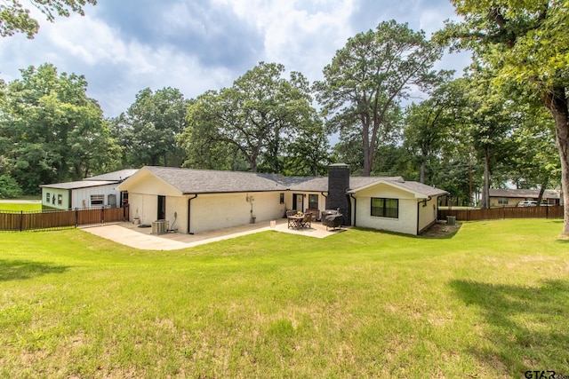 back of house featuring a patio, a yard, and central AC unit