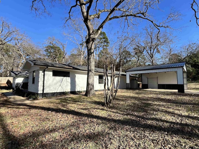 exterior space featuring a garage and an outdoor structure