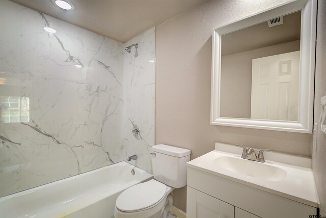 full bathroom with vanity, toilet, and tiled shower / bath