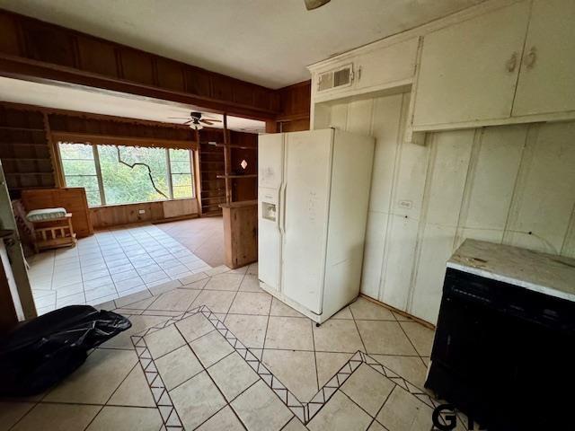 kitchen with ceiling fan, light tile patterned floors, and white fridge with ice dispenser