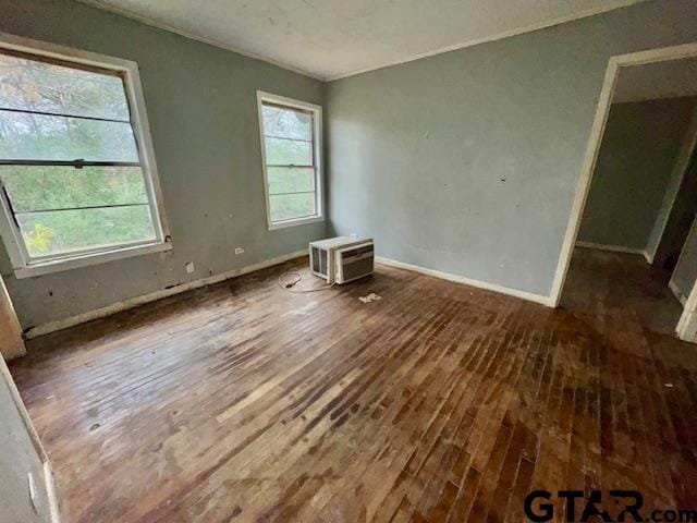 interior space with dark wood-type flooring and a wall mounted air conditioner