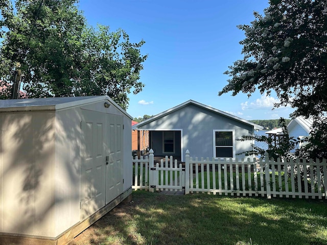 view of property exterior featuring a yard and a storage shed