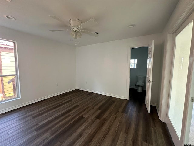 unfurnished room featuring dark hardwood / wood-style floors and ceiling fan