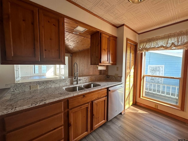 kitchen featuring light stone counters, crown molding, sink, light hardwood / wood-style floors, and stainless steel dishwasher