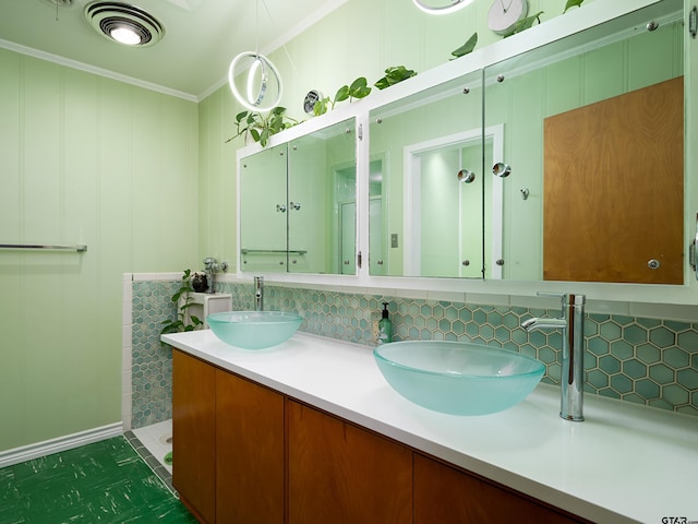 bathroom featuring vanity, crown molding, and tasteful backsplash