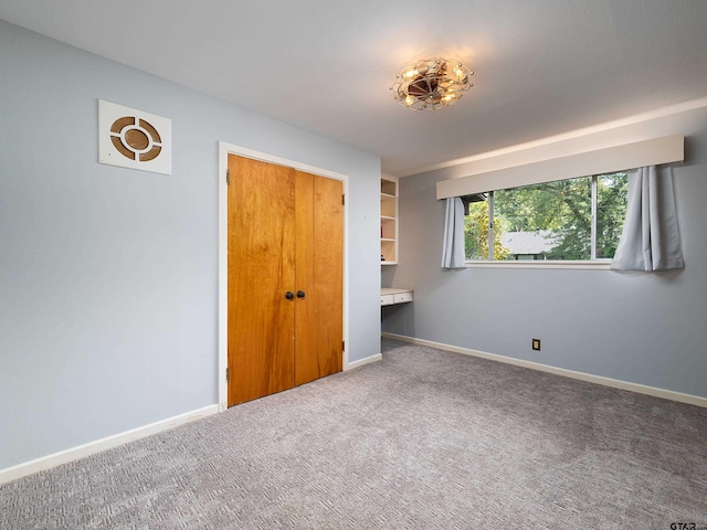 unfurnished bedroom with carpet flooring and a closet