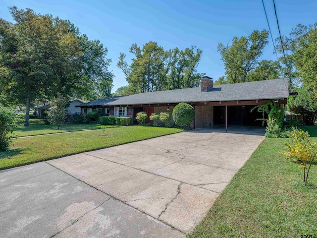 ranch-style house featuring a carport and a front lawn