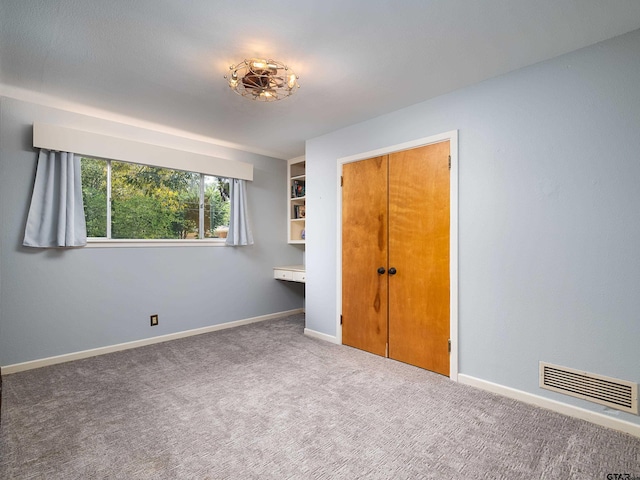 unfurnished bedroom with a closet and carpet floors