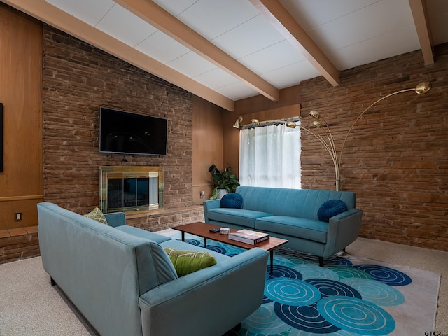 living room with a stone fireplace, carpet flooring, wood walls, and vaulted ceiling with beams