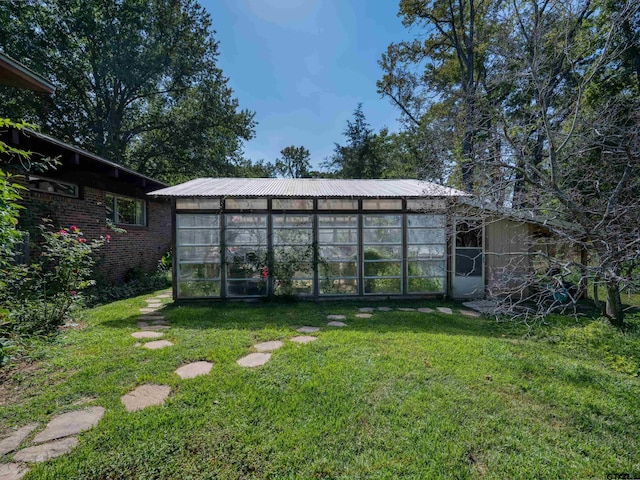 view of yard with a sunroom