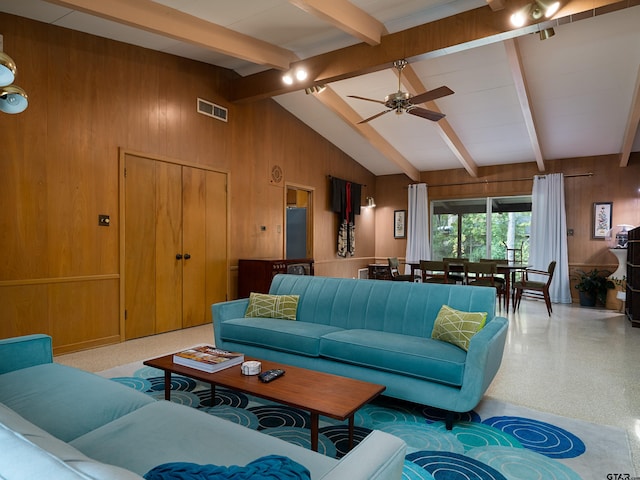 living room with ceiling fan and vaulted ceiling with beams