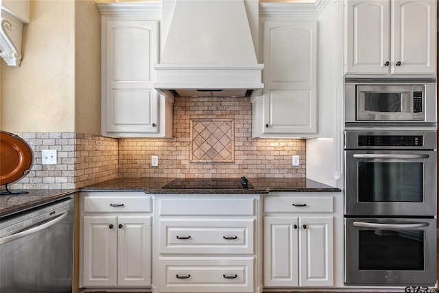 kitchen featuring custom exhaust hood and white cabinetry