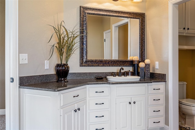 bathroom featuring toilet and vanity