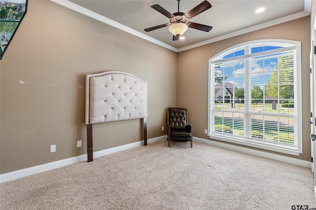 unfurnished room with carpet, crown molding, and plenty of natural light