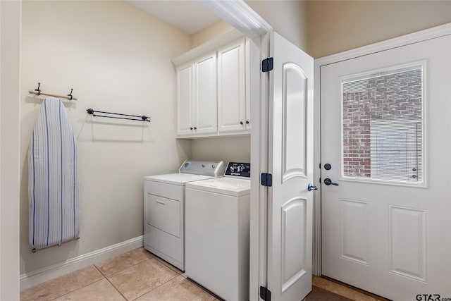 laundry room featuring cabinets, independent washer and dryer, and light tile patterned flooring