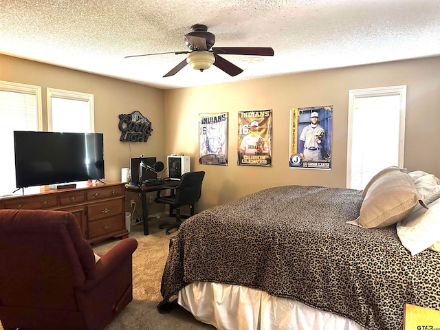 bedroom with a textured ceiling, ceiling fan, and carpet floors