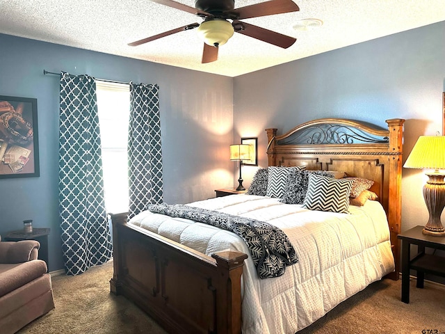 bedroom with ceiling fan, a textured ceiling, and carpet flooring