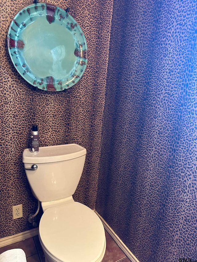 bathroom with toilet and tile patterned flooring