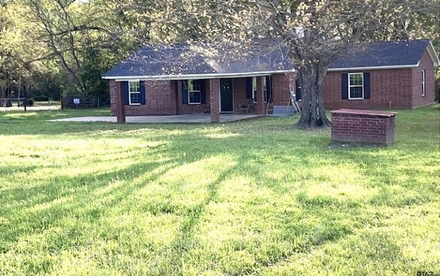 view of front of house with a front lawn and a patio area