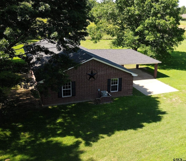 view of side of home with a patio and a yard